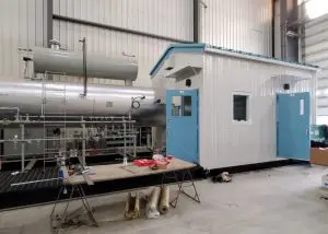 a metal machine being built inside a warehouse