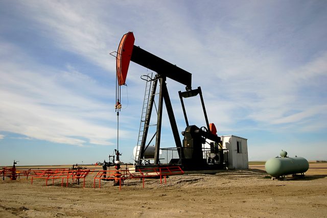 An oil pump jack in an empty brownfield