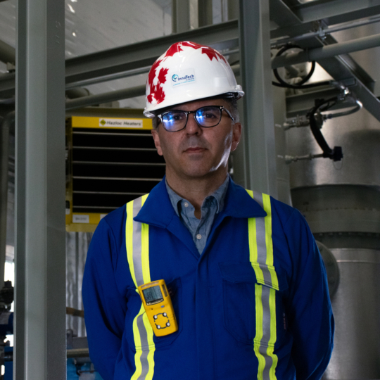 Man wearing hardhat and blue work jumpsuit
