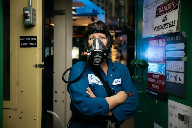 Female InnoTech employee wearing gas mask
