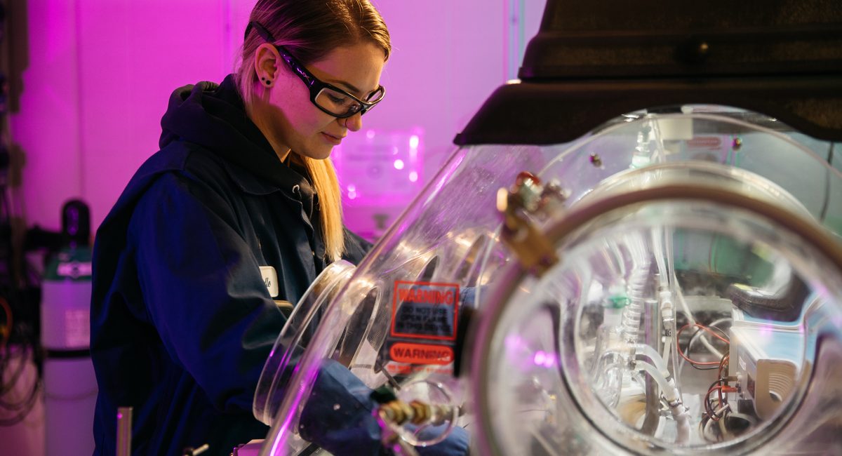 Female InnoTech employee wearing goggles working