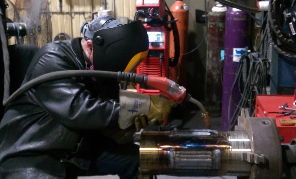Man wearing welding gear working