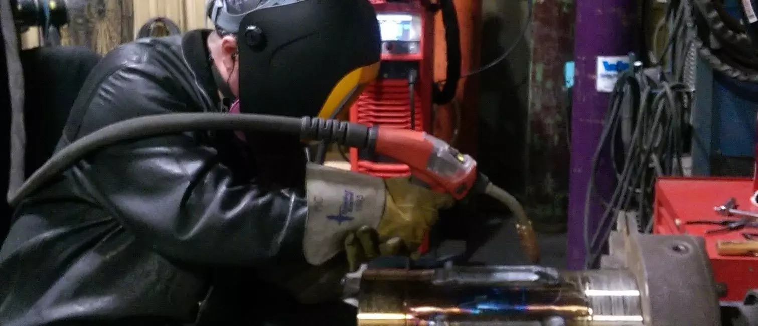 Man wearing welding gear working