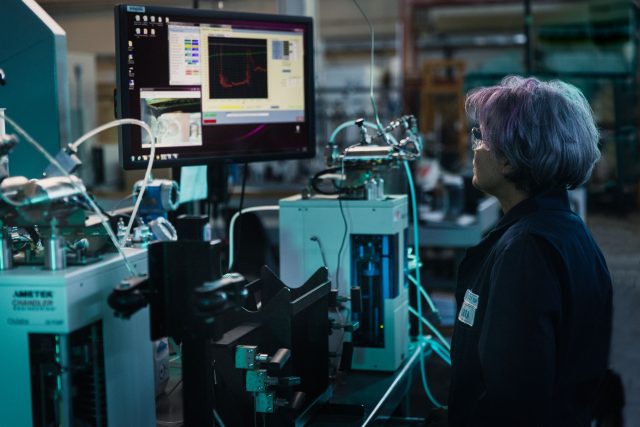 Lab technician looking at a computer screen