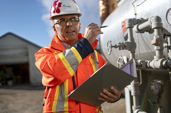 A picture of Aref Najafi in the field wearing a hardhat.